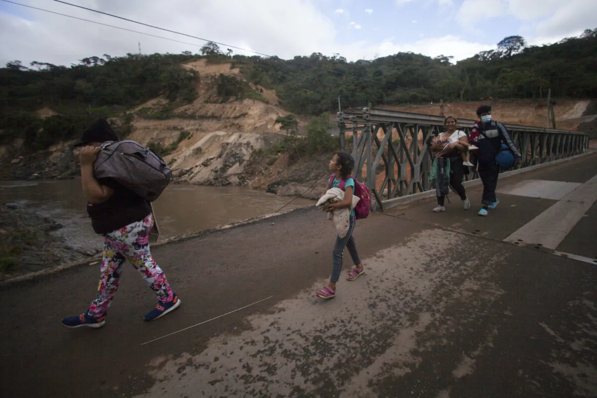 Migrants hoping to reach the distant U.S. border walk along a highway, in Jocotan, Guatemala, on Jan. 16, 2021.  (Sandra Sebastian/AP Photo)