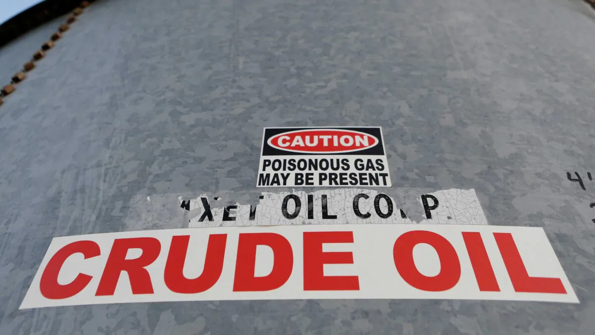 A sticker reads crude oil on the side of a storage tank in the Permian Basin in Mentone, Loving County, Texas, on Nov. 22, 2019. (Angus Mordant/Reuters)