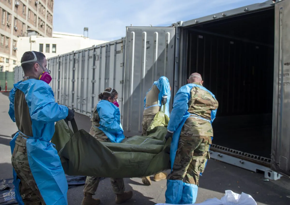National Guard members assisting with processing COVID-19 deaths, placing them into temporary storage at the medical examiner-coroner's office in Los Angeles, Calif., on  Jan 12, 2021. (Los Angeles County Department of Medical Examiner-Coroner via AP, File) 