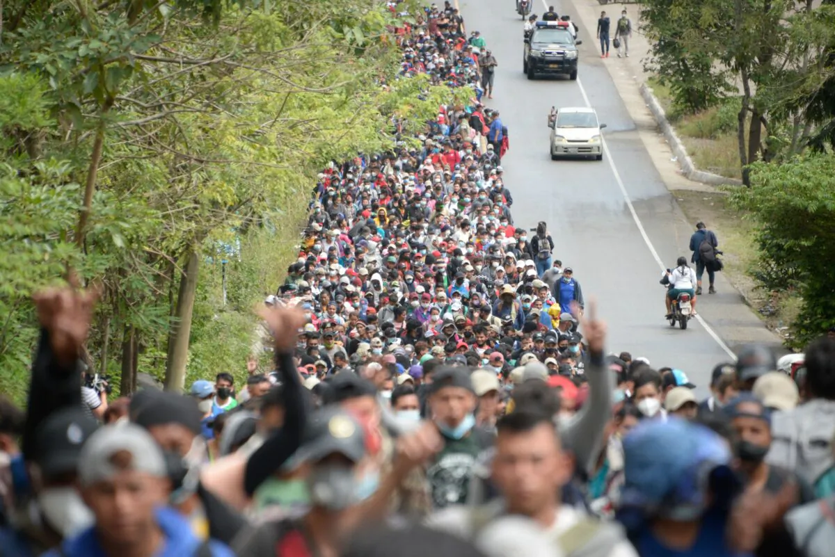 Honduran migrants, part of a caravan heading to the United States, walk along a road in Camotan, Guatemala, on Jan. 16, 2021. (Johan Ordonez/AFP via Getty Images)
