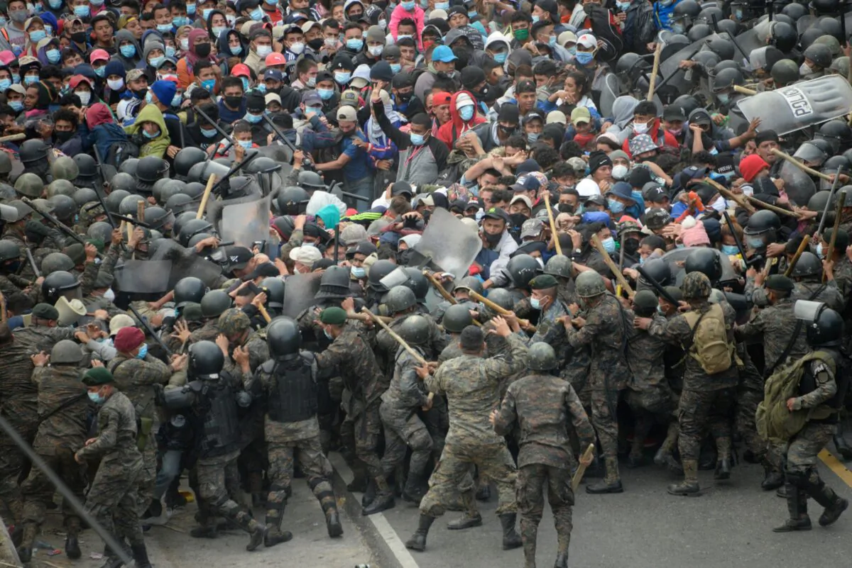 Honduran migrants, part of a caravan heading to the United States, clash with Guatemalan security forces in Vado Hondo, Guatemala, on Jan. 17, 2021. (Johan Ordonez/AFP via Getty Images)