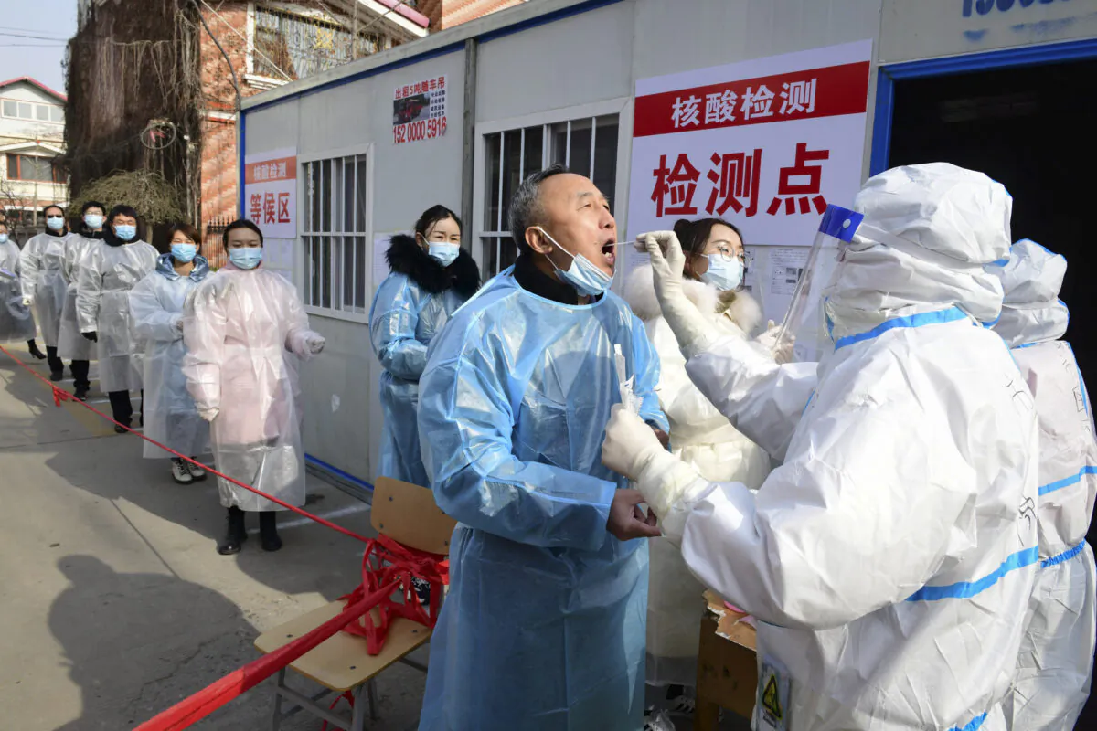 Residents undergo COVID-19  tests at a makeshift testing center inside a residential compound in Shijiazhuang, in northern Hebei Province on Jan. 16, 2021.(STR/CNS/AFP via Getty Images)