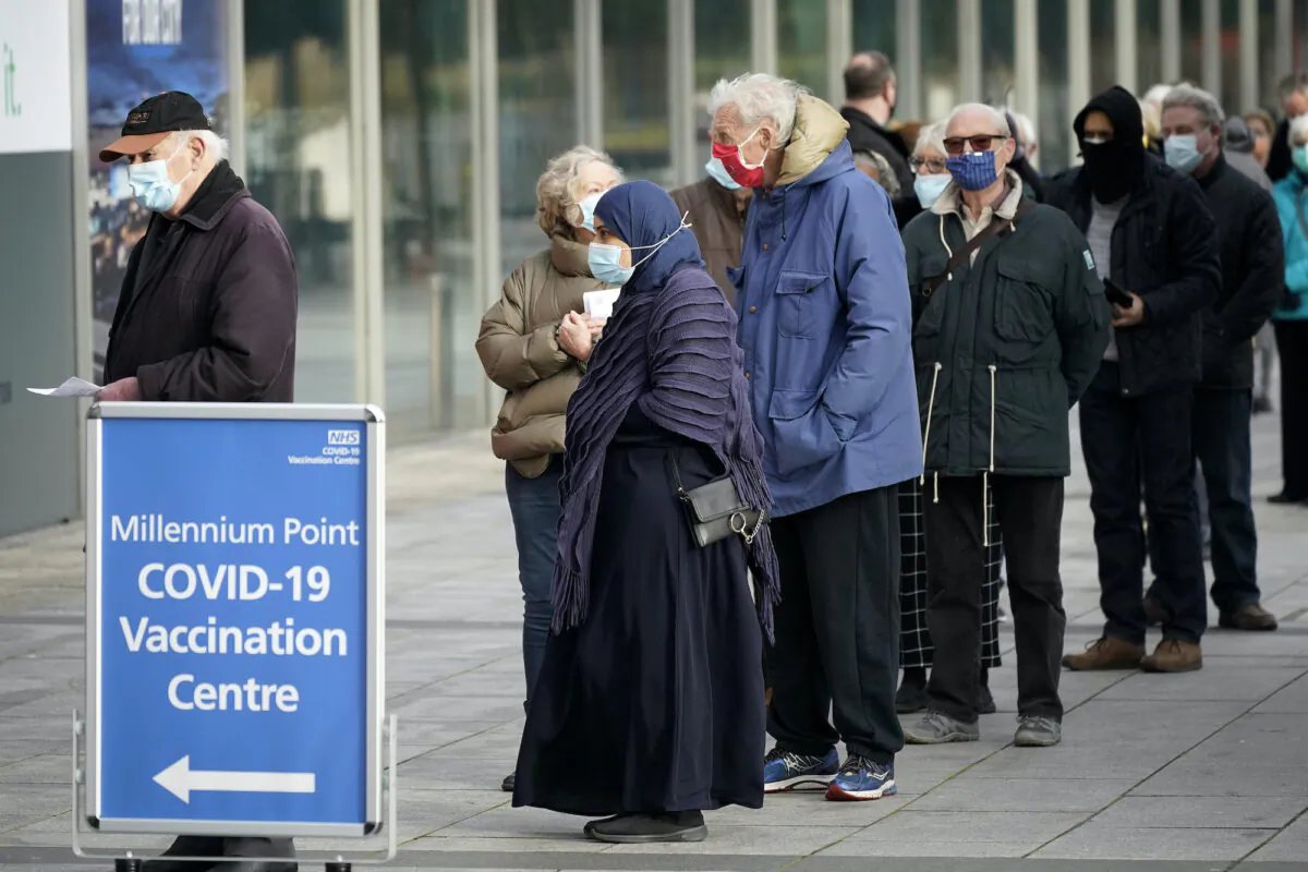 People stand in line outside the mass NHS vaccination center that has been set up at the Millennium Point center in Birmingham, England, on Jan. 11, 2021. (Christopher Furlong/Getty Images)