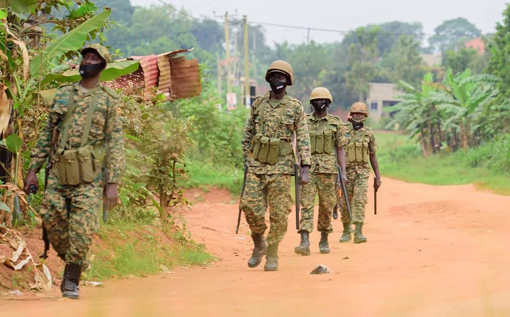 Soldiers patrol outside opposition challenger Bobi Wine's home in Magere, Kampala, Uganda, on Jan. 16, 2021, after President Yoweri Museveni was declared the winner of the presidential election. (AP Photo/Nicholas Bamulanzeki)