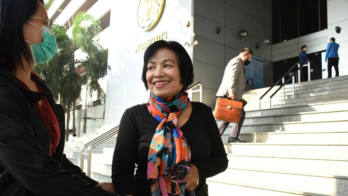 A woman identified only by her first name Anchan (R) talks to her friend as she arrives at the Bangkok Criminal Court in Bangkok, Thailand, on Jan. 19, 2021. (AP Photo)