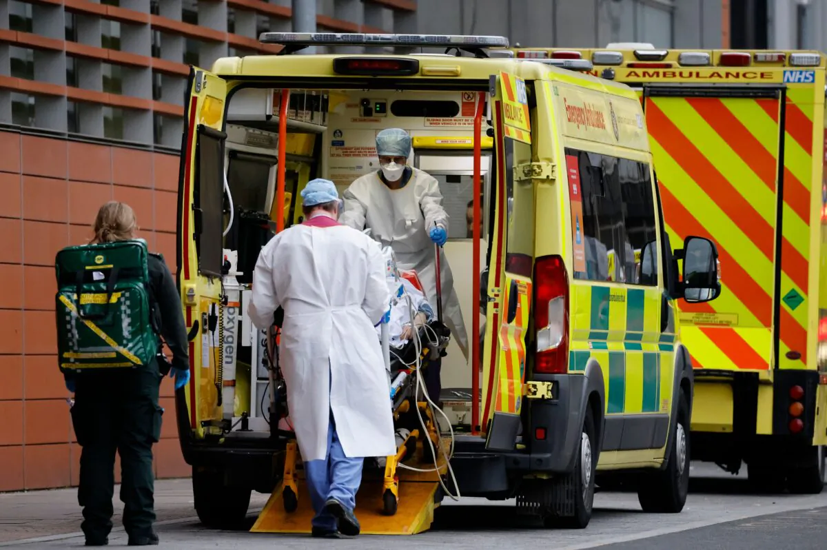 Medics take a patient from an ambulance into the Royal London Hospital in London on Jan. 19, 2021. (Tolga Akmen /AFP via Getty Images)