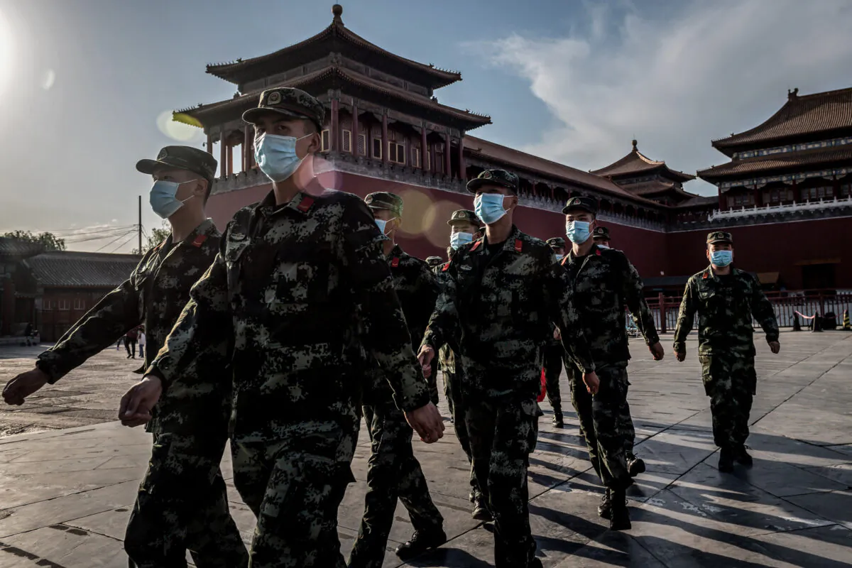People's Liberation Army (PLA) soldiers march in front of the entrance of the Forbidden City in Beijing on May 19, 2020. (Nicolas Asfouri/AFP via Getty Images)