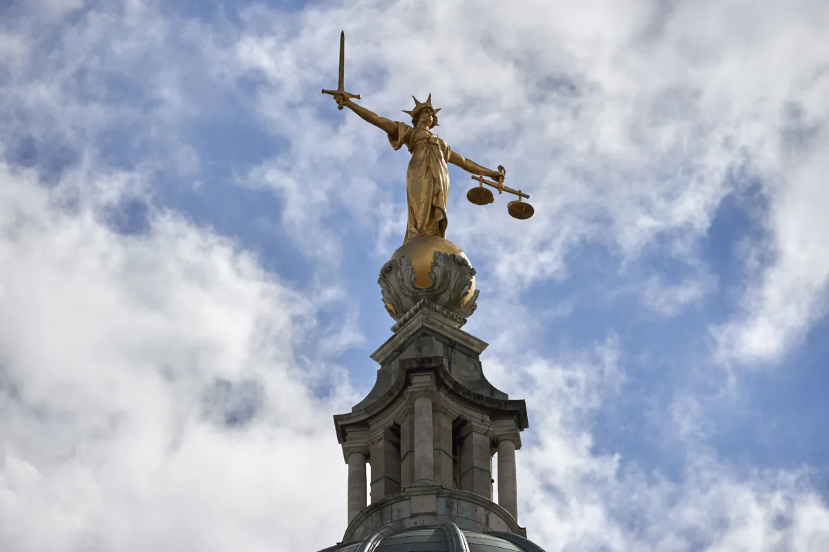 The 'Lady of Justice,' a 12-foot-high gold leaf statue, is pictured on top of the dome of the Central Criminal Court, commonly referred to as the Old Bailey, in central London on Aug. 21, 2016. (Niklas Halle'n/AFP via Getty Images)