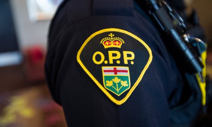 An Ontario Provincial Police crest is displayed on the arm of an officer during a press conference in Vaughan, Ont., on June 20, 2019. (Andrew Lahodynskyj/The Canadian Press)