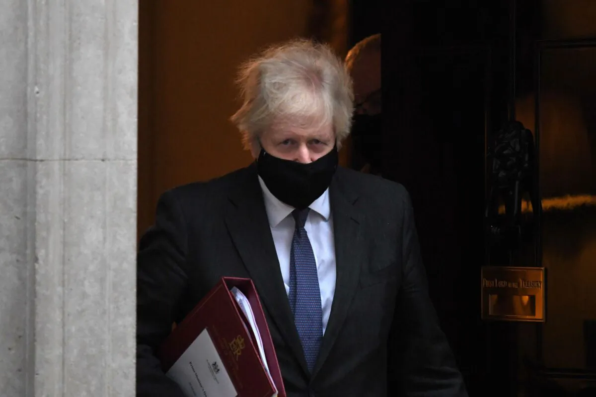 Britain's Prime Minister Boris Johnson leaves 10 Downing Street in London to take part in the weekly session of Prime Minister Questions (PMQs) at the House of Commons on Jan. 20, 2021. (Daniel Leal-Olivas/AFP via Getty Images)