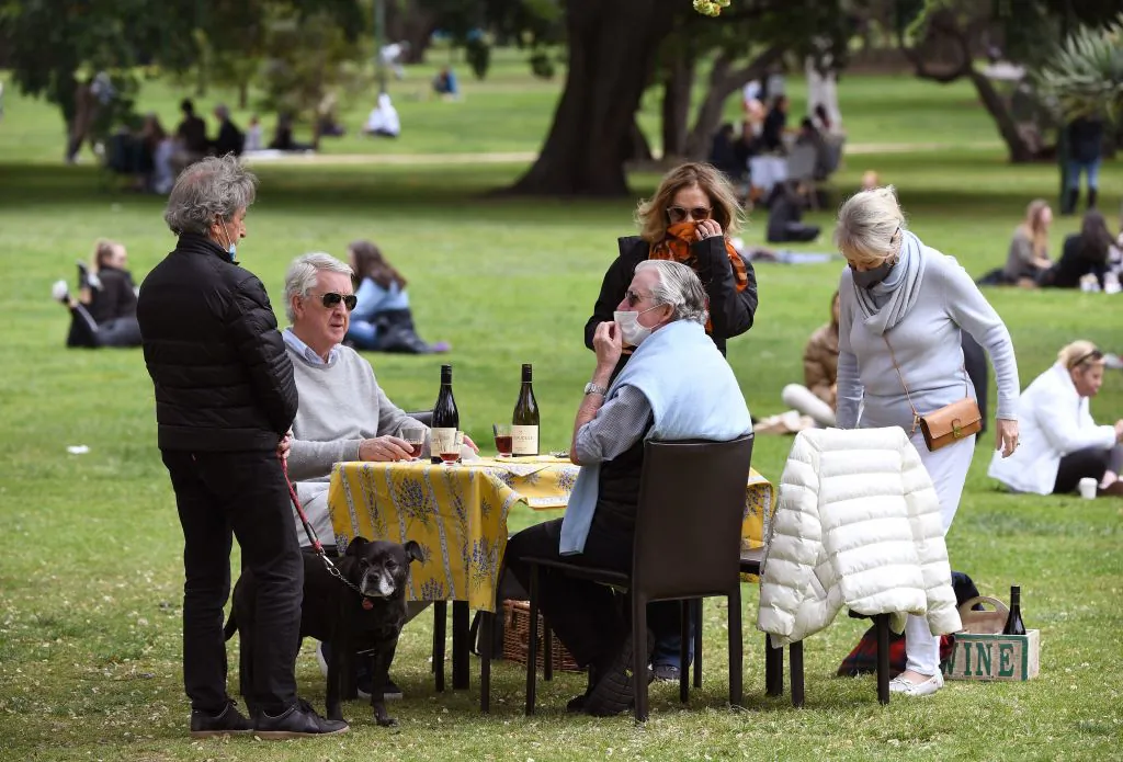 People have a picnic in a park in Melbourne on Oct. 18, 2020, as the state government announced a lifting of some COVID-19 restrictions. (William West/AFP via Getty Images)