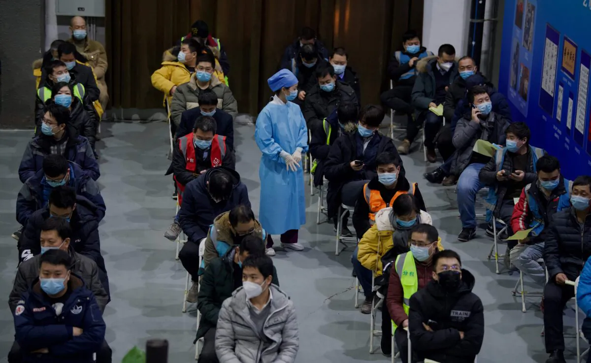 People wait to be inoculated with a COVID-19 vaccine at the Chaoyang Museum of Urban Planning in Beijing, on Jan. 15, 2021. (NOEL CELIS/AFP via Getty Images)