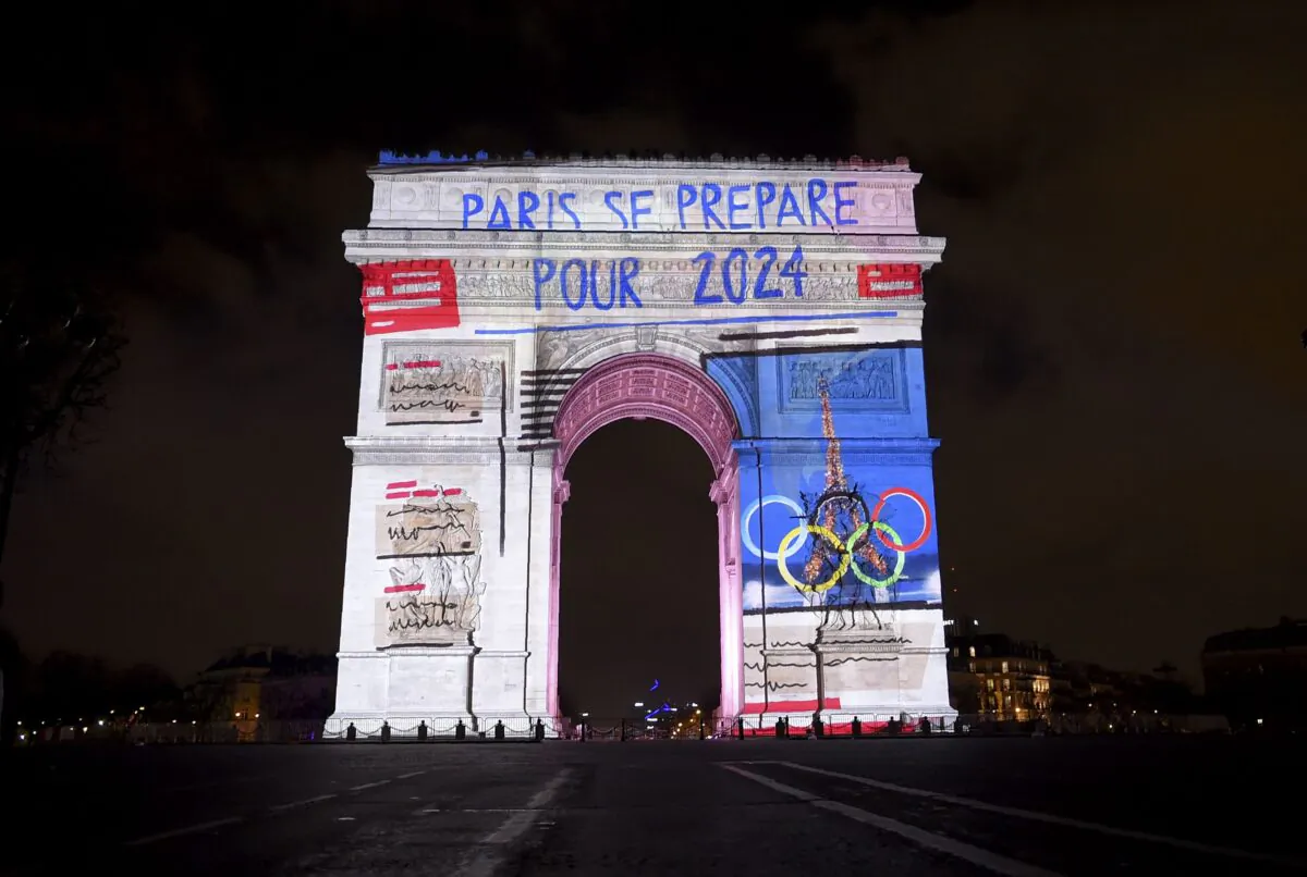 Images with a slogan reading "Paris is getting ready for 2024," referring to the 2024 Olympic Games that Paris was awarded, are projected on the Arc de Triomphe monument during a laser and 3D video mapping show as part of the New Year celebrations in Paris on Dec. 31, 2017. (Guillaume Souvant/AFP via Getty Images)