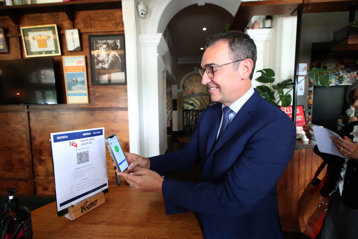 South Australian Premier Steven Marshall demonstrates checking in via QR code to help with contact tracing at the Stag Hotel on December 01, 2020 in Adelaide, Australia. (Kelly Barnes/Getty Images)