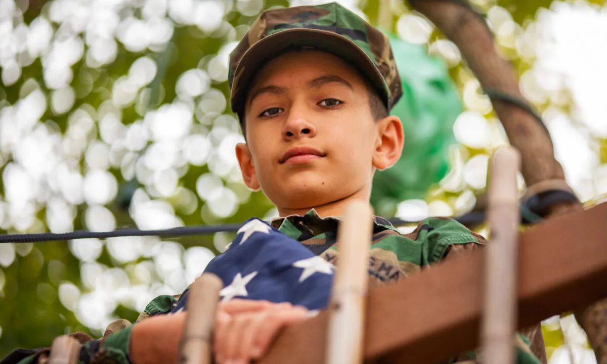 11-year-old Jordan Ramirez holds a folded American flag at his home in La Puente, Calif., on Jan. 19, 2021. (John Fredricks/The Epoch Times)