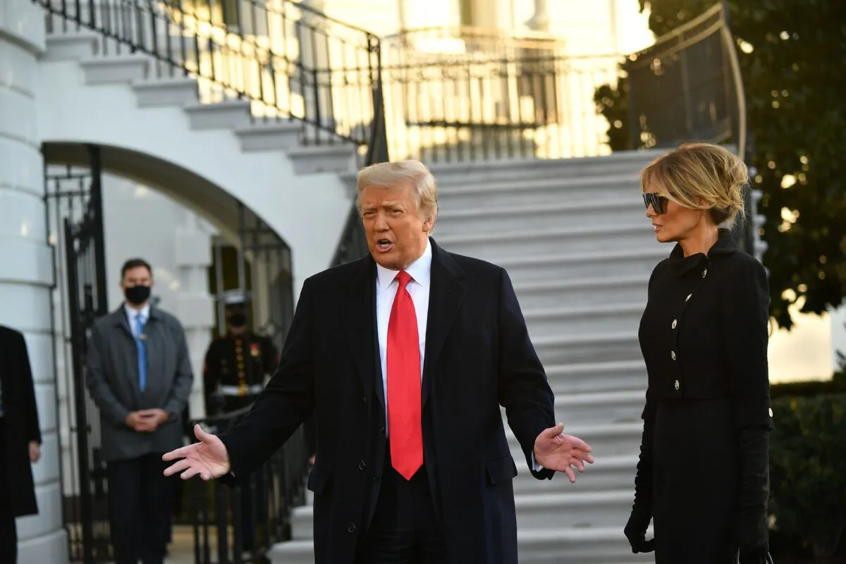 President Donald Trump and First Lady Melania Trump speak to the media before departing Washington for Florida, outside the White House on Jan. 20, 2021. (Mandel Ngan/AFP via Getty Images)