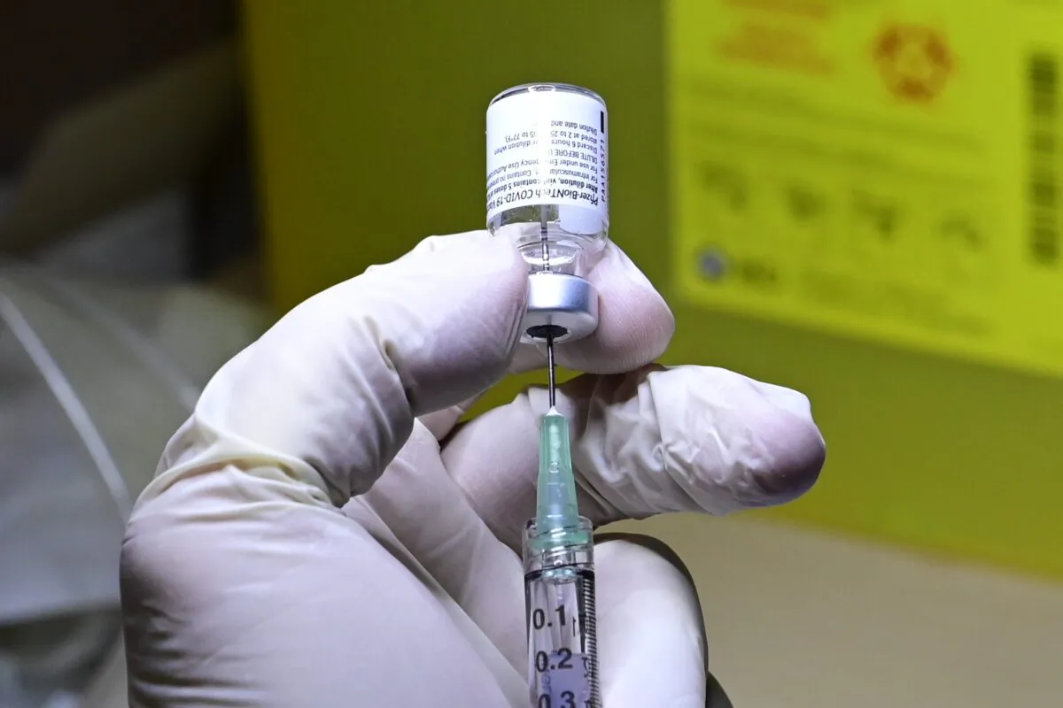 A COVID-19 vaccine is prepared to be administered at a hospital in Toronto on Dec. 14, 2020. (Frank Gunn/The Canadian Press)