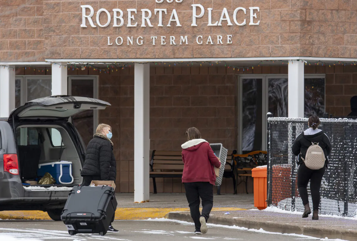 Workers arrive at the Roberta Place Long Term Care home in Barrie, Ont., Canada, on Jan. 18, 2021. (Frank Gunn/The Canadian Press)