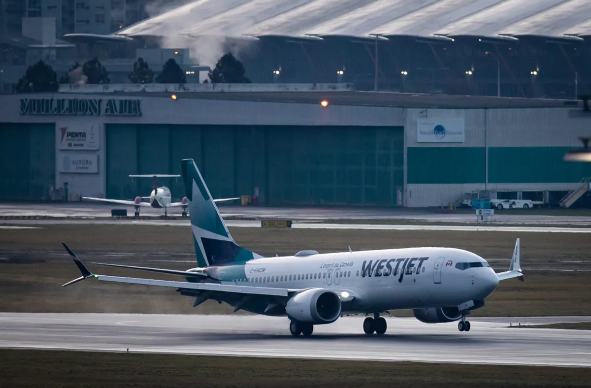 A WestJet Airlines Boeing 737 Max aircraft arrives at Vancouver International Airport in Richmond, B.C., on Jan. 21, 2021. The flight from Calgary is the first commercial Boeing 737 Max flight in Canada since the aircraft was grounded worldwide in 2019 following two deadly crashes. (Darryl Dyck/The Canadian Press)
