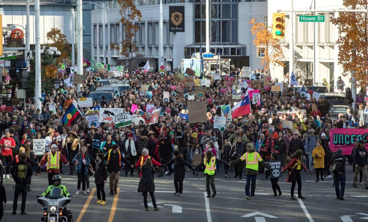 A student-led climate change march makes its way through downtown Vancouver on Oct. 25, 2019. (The Canadian Press/Darryl Dyck)