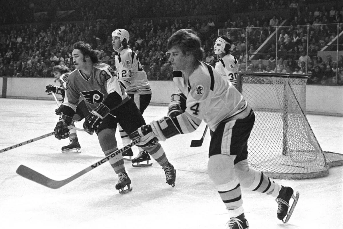 The renowned Bobby Orr of the Boston Bruins (R) passes the puck during a game at the Boston Garden on Feb. 9, 1974. Next to him is the Philadelphia Flyers' Rick MacLeish. (The Canadian Press/AP)