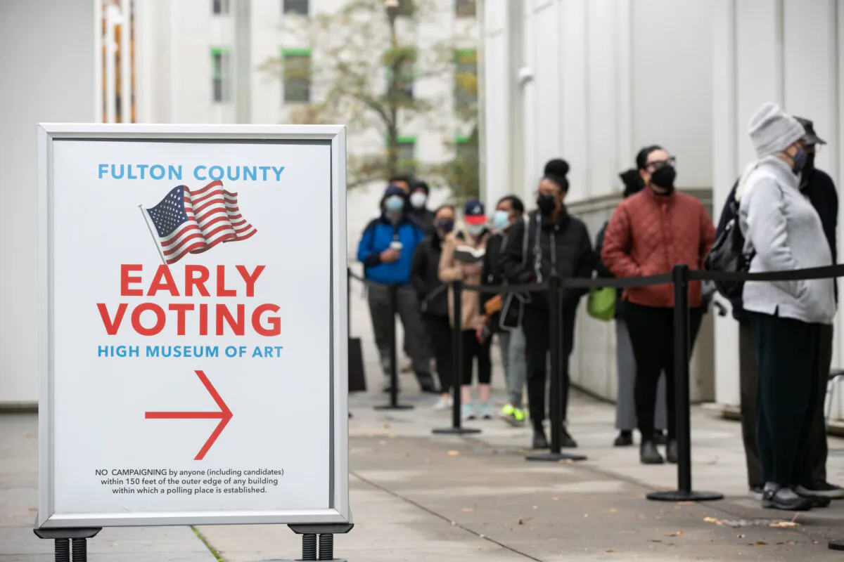 A file image of voters standing in line to cast their ballots during the first day of early voting in the U.S. Senate runoff, in Atlanta, Ga., on Dec. 14, 2020. (Jessica McGowan/Getty Images)