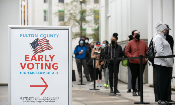 Voters stand in line to cast their ballots during the first day of early voting in the U.S. Senate runoff, in Atlanta, Ga., on Dec. 14, 2020. (Jessica McGowan/Getty Images)