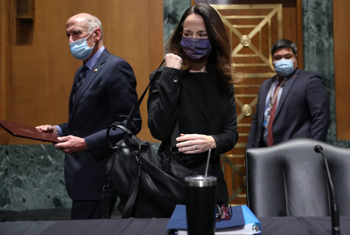 Avril Haines (C) and Dan Coats (L), former Director of National Intelligence, arrive at the start of the Senate Intelligence Committee confirmation hearing in Washington to consider her to be President Joe Biden’s pick for national intelligence director on Jan. 19, 2021. (Joe Raedle/Getty Images)