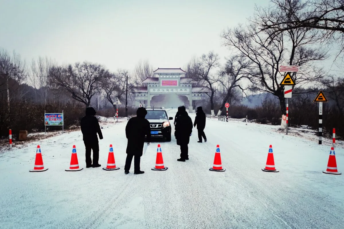 Occupants of a car are banned from leaving Ang'angxi district in Qiqihar as northeastern China's Heilongjiang Province declares an "emergency state," telling residents not to leave unless absolutely necessary, after new coronavirus cases were detected. (AFP via Getty Images)