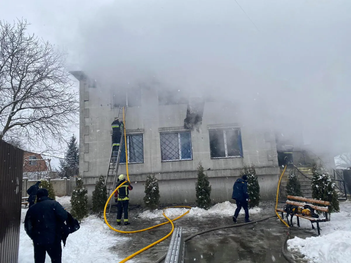 Rescuers work at the scene of the accident following a fire in nursing home in Kharkiv, Ukraine January 21, 2021. State Emergency Service of Ukraine/Handout via REUTERS