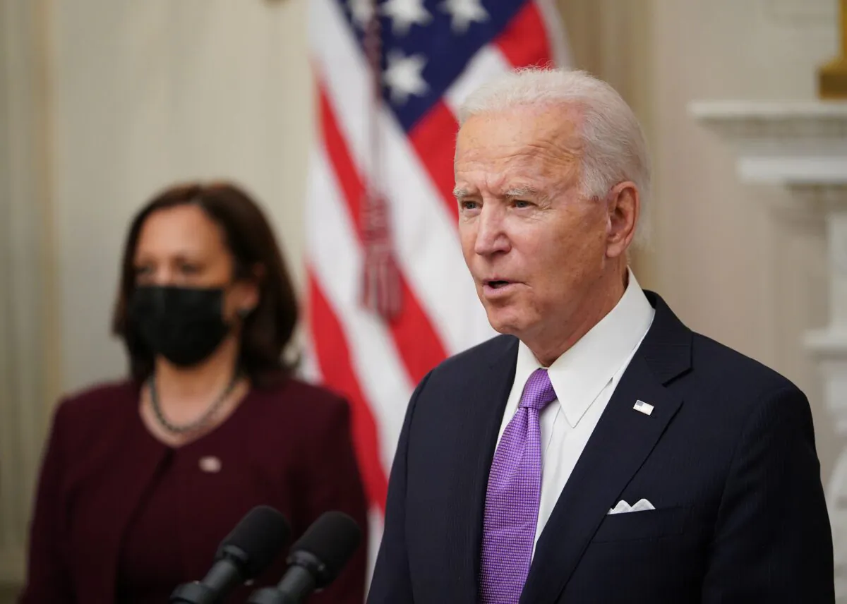 President Joe Biden speaks about the COVID-19 response as Vice President Kamala Harris (L) looks on before signing executive orders in the State Dining Room of the White House on Jan. 21, 2021. (Mandel Ngan/AFP via Getty Images)