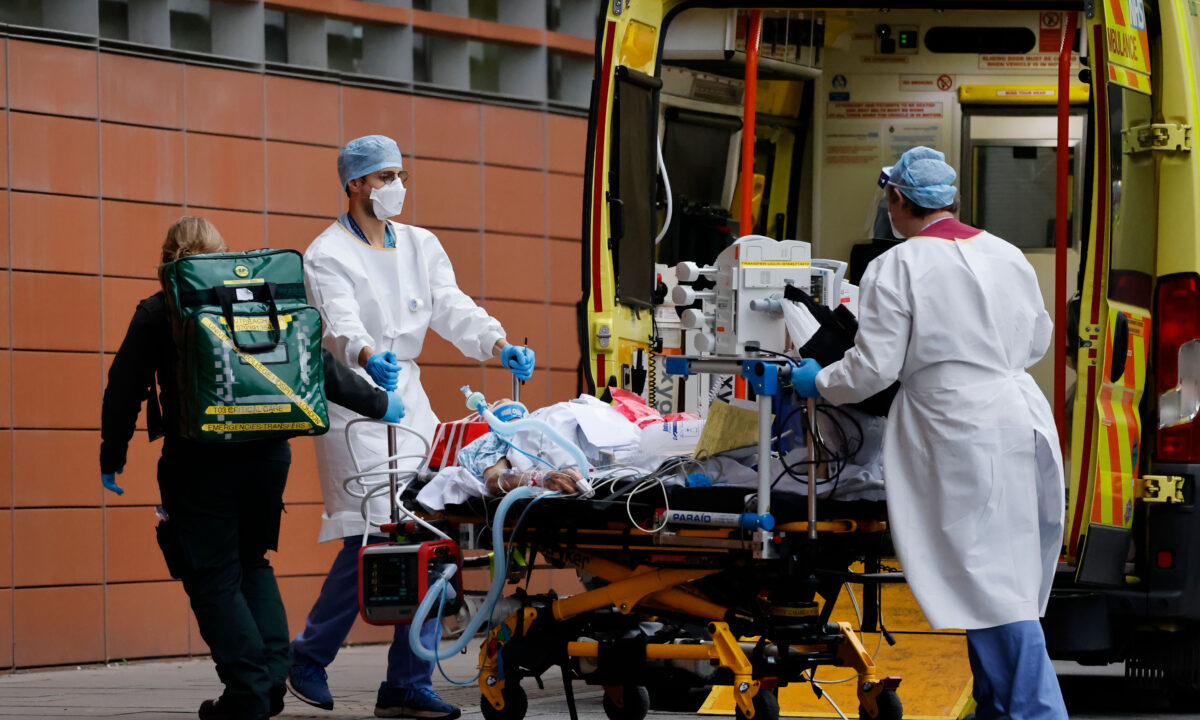 Medics take a patient from an ambulance into the Royal London hospital in London on Jan. 19, 2021.(Tolga Akmen/AFP via Getty Images)