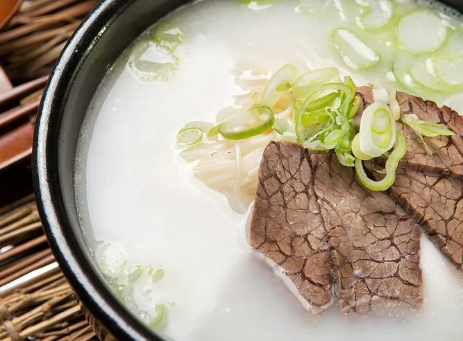 Unlike clear bone broths, seolleongtang is an opaque, creamy white, achieved by boiling—not simmering—the bones, coaxing out all of the flavor, collagen, marrow, and fat. (TMON/Shutterstock)