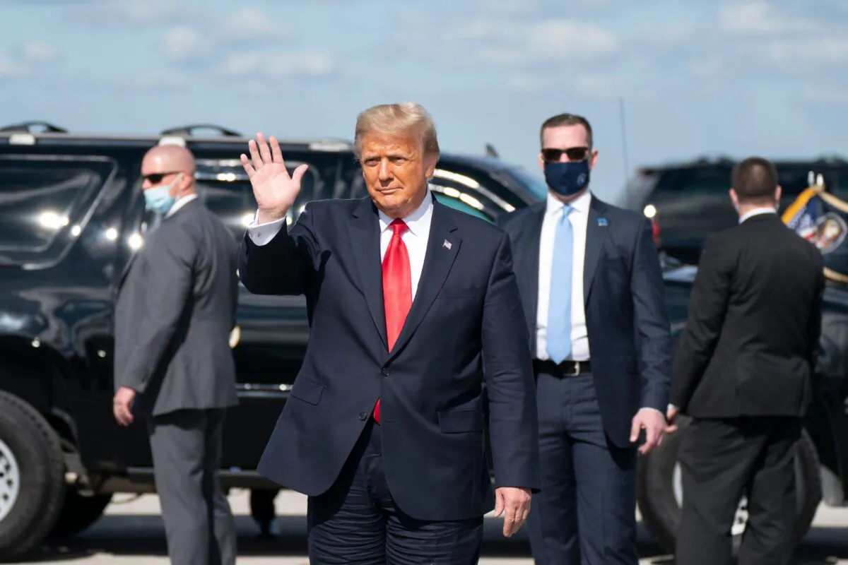 Outgoing U.S. President Donald Trump waves after landing at Palm Beach International Airport in West Palm Beach Fla., on Jan. 20, 2021. (Alex Edelman/AFP via Getty Images)