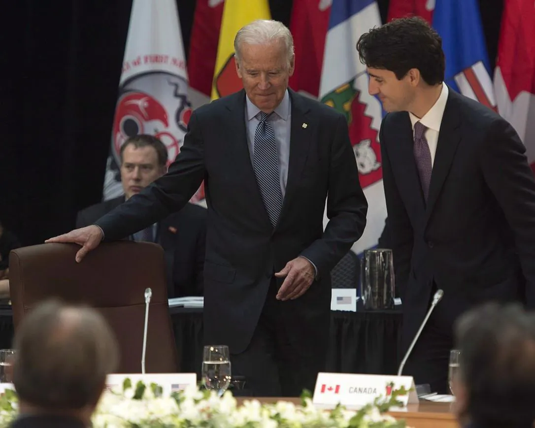 Joe Biden, then the U.S. vice-president, and Prime Minister Justin Trudeau take their seats at the start of the First Ministers and National Indigenous Leaders meeting in Ottawa, on Dec. 9, 2016. (Adrian Wyld/The Canadian Press)
