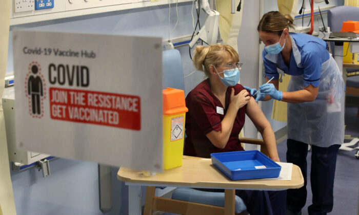 Deputy charge nurse, Katie McIntosh administers the first of two Pfizer/BioNTech COVID-19 vaccine jabs at the Western General Hospital in Edinburgh, Scotland, on Dec. 8, 2020. (Andrew Milligan - Pool / Getty Images)