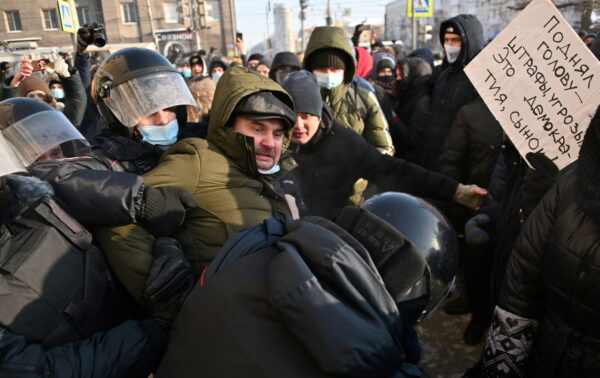 Police restrain man during Moscow rally