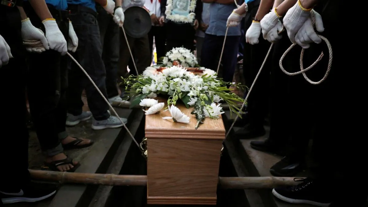 Locals and relatives of Anna Bui Thi Nhung, one of the 39 Vietnamese people found dead in a truck near London in October, prepare bury her coffin during her funeral at a cemetery in Nghe An province, Vietnam, on Dec. 1, 2019. (Kham/Files, Reuters)