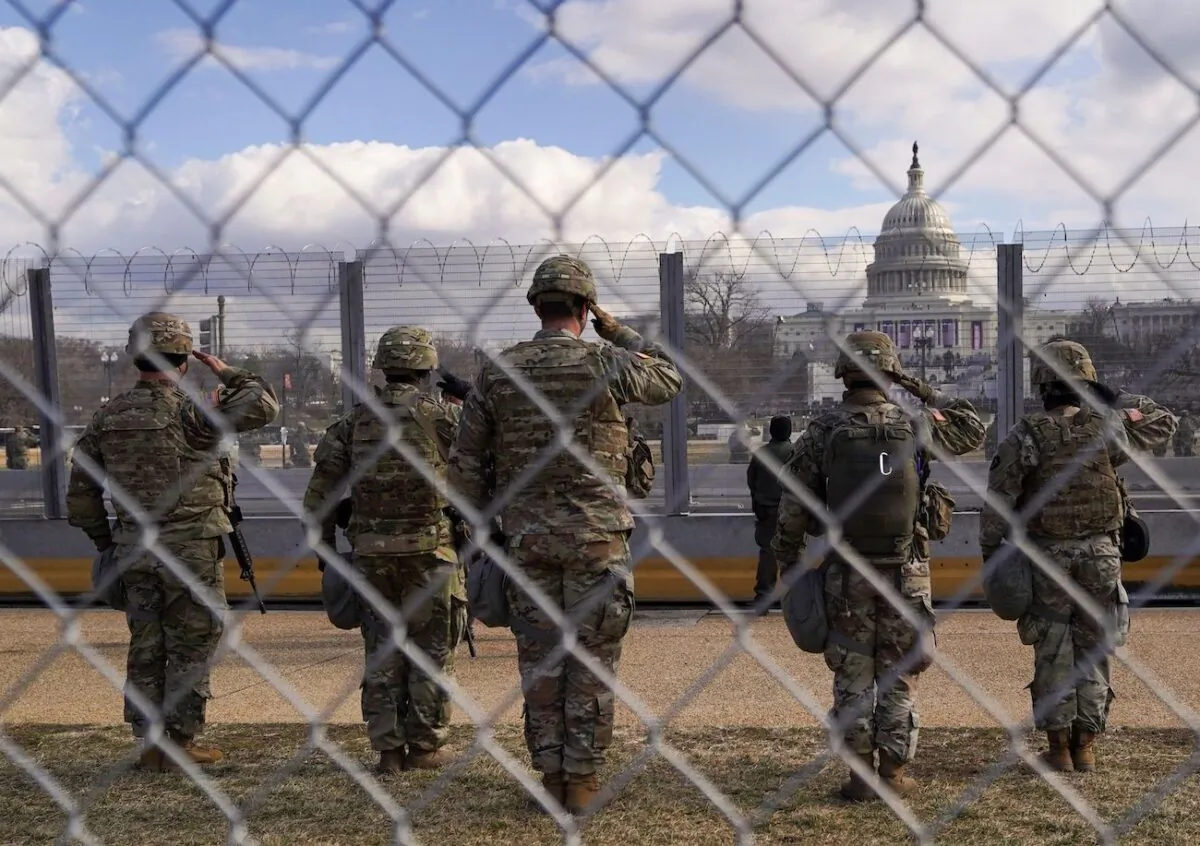 National Guard members salute in front of the U.S. Capitol building in Washington, Jan. 20, 2021. (Allison Shelley/Reuters)