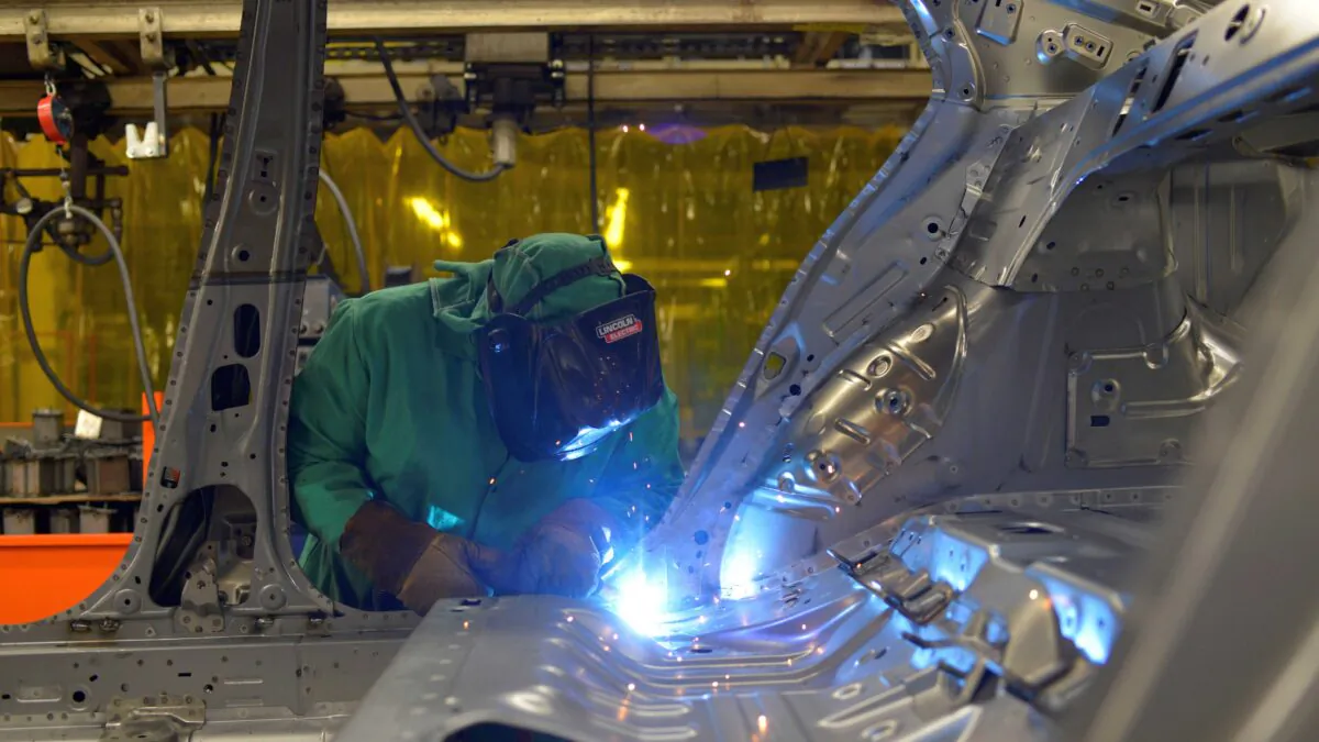 Line workers spot weld parts of the frame on the flex line at Nissan Motor Co’s automobile manufacturing plant in Smyrna, Tenn., on Aug. 23, 2018. (William DeShazer/Reuters)