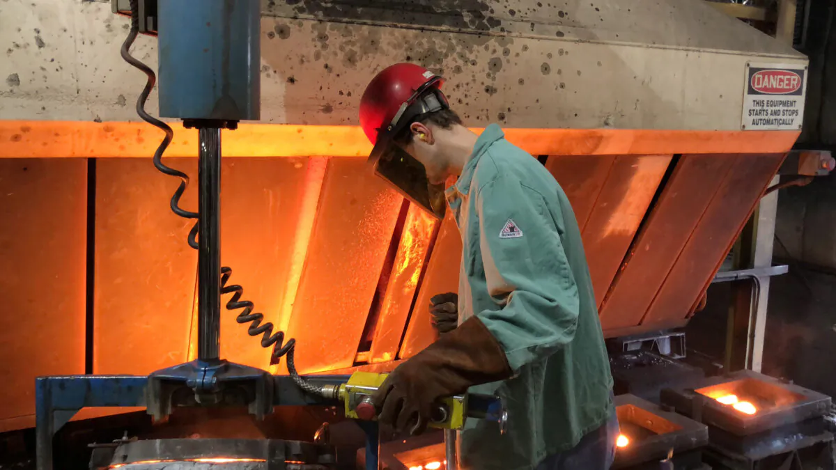 A worker pours hot metal at the Kirsh Foundry in Beaver Dam, Wis., on April 12, 2018. (Timothy Aeppel/Reuters)