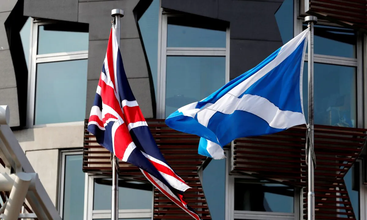 A Scottish flag flies next to British Union Jack flag outside the Scottish Parliament in Edinburgh, Scotland, Britain, on April 24, 2019. (Russell Cheyne/Reuters)