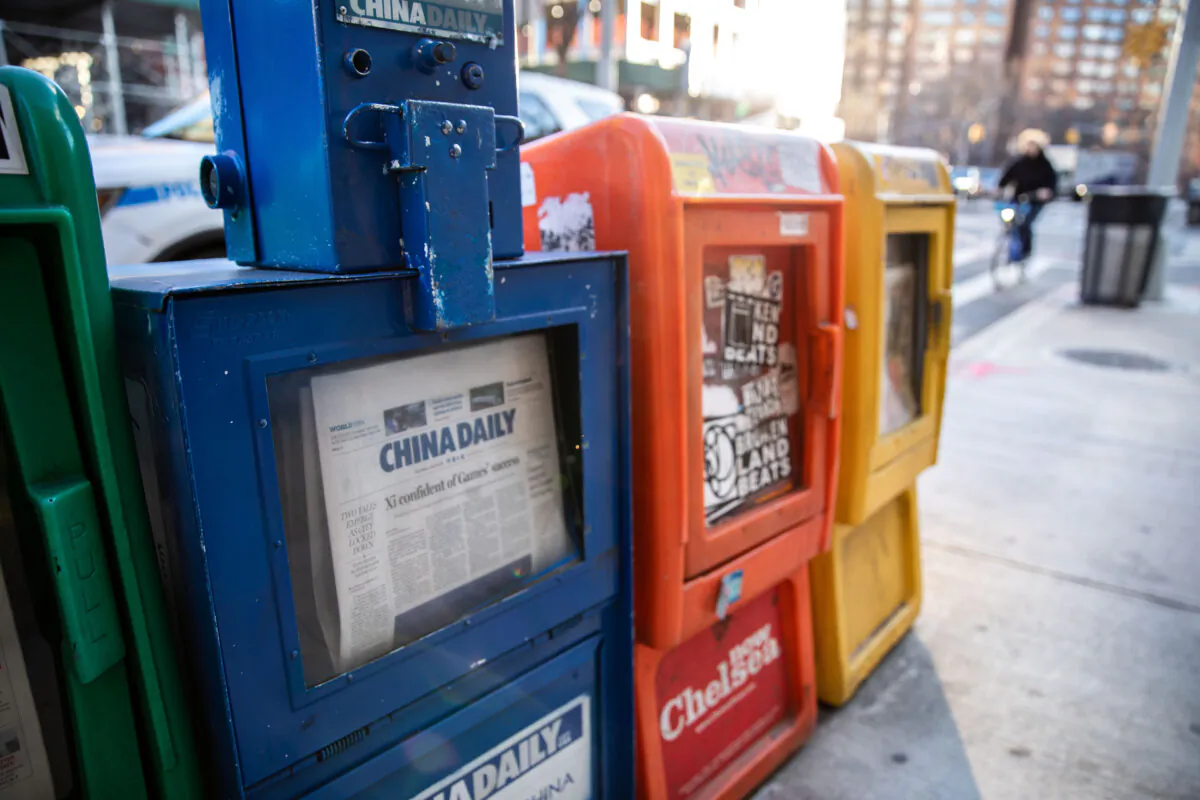 A China Daily newspaper box is with other free daily papers in New York on Jan. 20, 2021. (Chung I Ho/The Epoch Times)