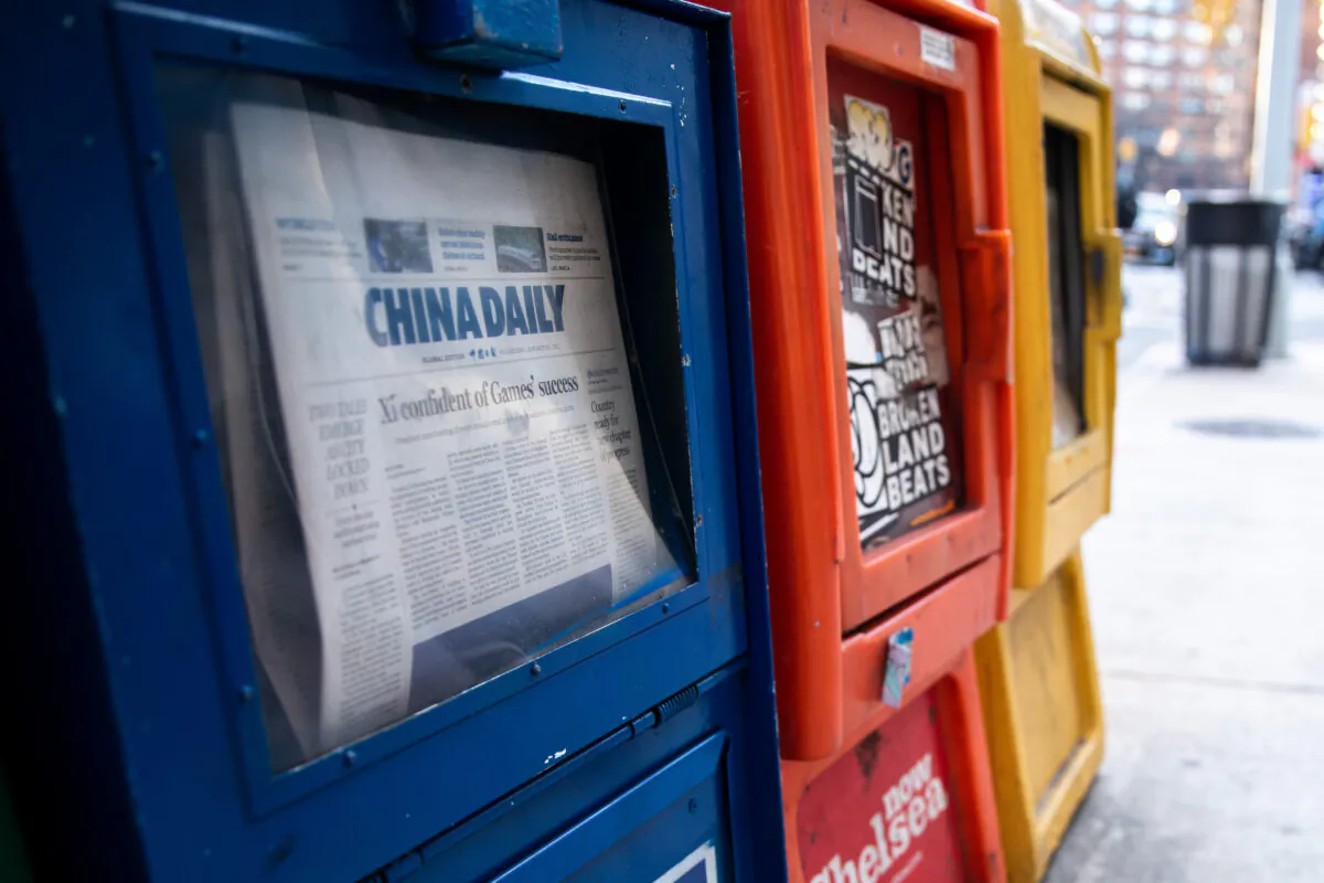 A China Daily newspaper box is with other free daily papers in New York on Jan. 20, 2021. (Chung I Ho/The Epoch Times)