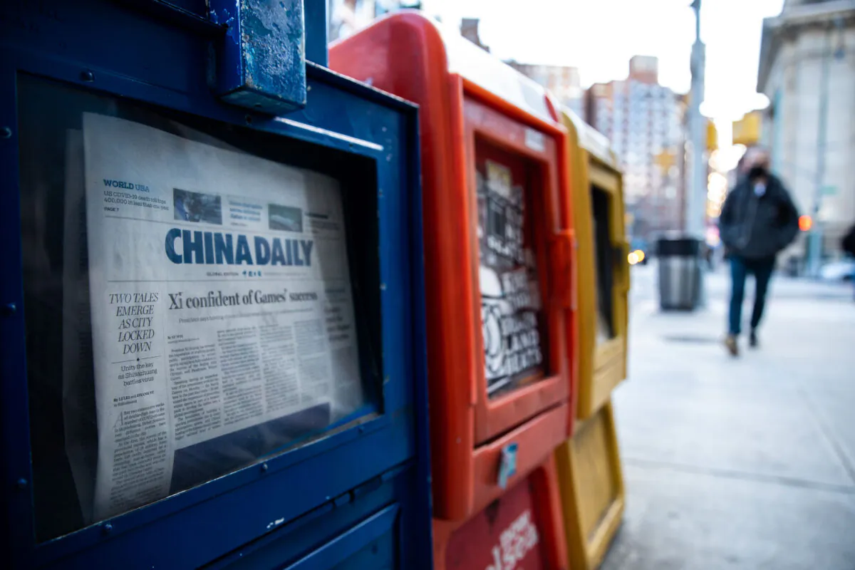 A China Daily newspaper box is with other free daily papers in New York on Jan. 20, 2021. (Chung I Ho/The Epoch Times)