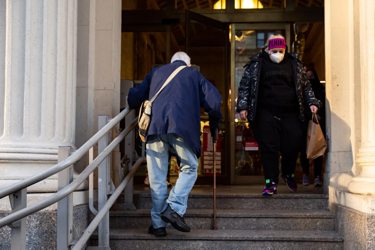 People enter and exit a pharmacy in New York on Jan. 20, 2021. (Chung I Ho/The Epoch Times)
