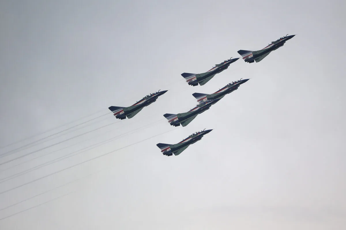 J-10 fighter jets of China's People's Liberation Army Air Force Ba Yi aerobatics team perform an aerial display during the Singapore Airshow media preview in Singapore on Feb. 9, 2020. (Suhaimi Abdullah/Getty Images)