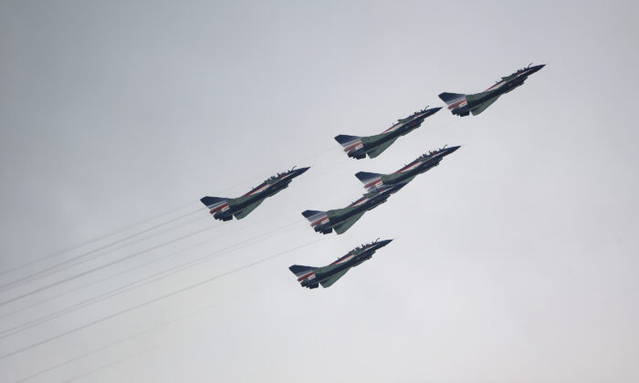 J-10 fighter jets of China's People's Liberation Army Air Force Ba Yi aerobatics team perform an aerial display during the Singapore Airshow media preview in Singapore on Feb. 9, 2020. (Suhaimi Abdullah/Getty Images)