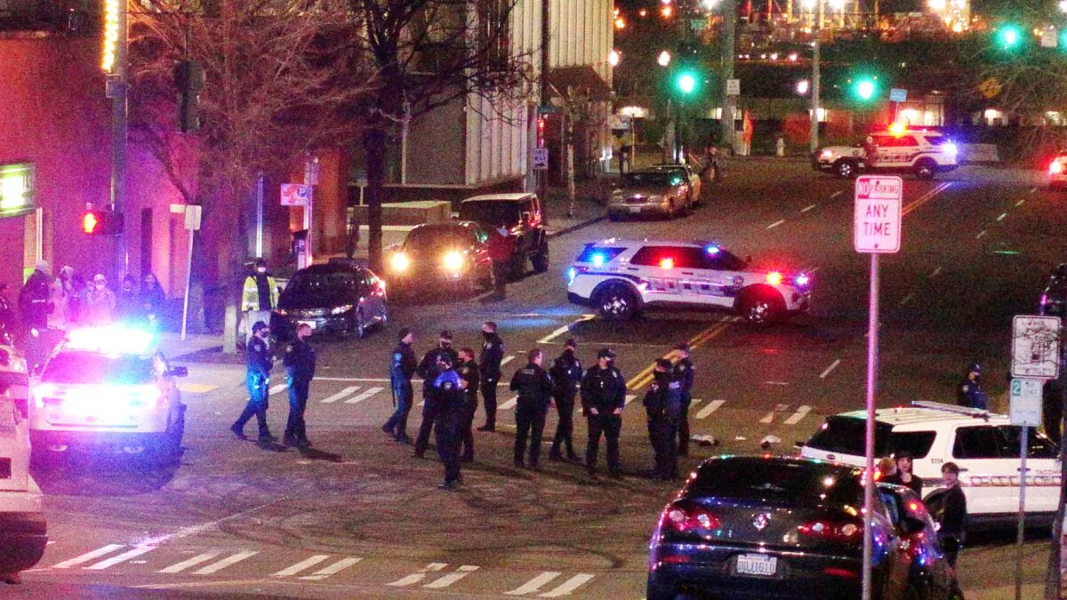 Tacoma Police and other law enforcement officers stand in an intersection near the site of a car crash in downtown Tacoma, Wash., on Jan. 23, 2021. (Ted S. Warren/AP Photo)