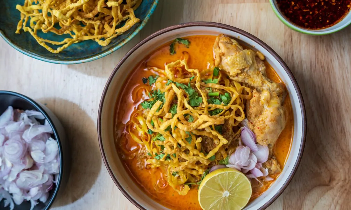 Khao soi is served with springy egg noodles and an assortment of toppings, including a crown of crispy fried noodles. (Sumate Treekajornsak/Shutterstock)